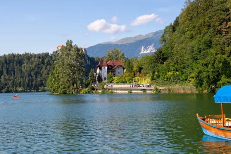 Winding road descending toward Lake Bled with the island church visible below